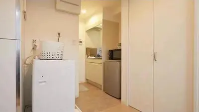a white kitchen with a refrigerator and a microwave at Marvelous Kinshicho - Vacation STAY 61712v in Tokyo