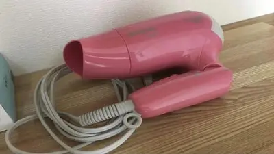 a pink blow dryer sitting on a wooden floor at Marvelous Kinshicho - Vacation STAY 61712v in Tokyo