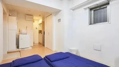 a bedroom with a bed with blue pillows on it at Marvelous Kinshicho - Vacation STAY 61712v in Tokyo