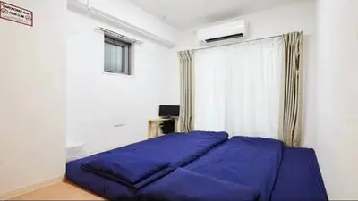 a bedroom with a large purple bed with a window at Marvelous Kinshicho - Vacation STAY 61712v in Tokyo