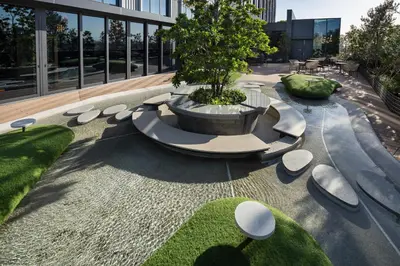 a courtyard with a fountain with a tree in it at OMO5 Tokyo Gotanda by Hoshino Resorts in Tokyo