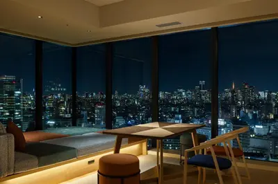 a room with a view of the city at night at OMO5 Tokyo Gotanda by Hoshino Resorts in Tokyo