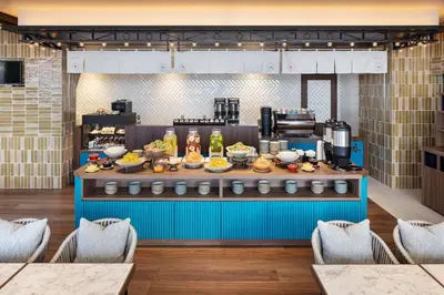 a buffet line with food on it in a restaurant at OMO5 Tokyo Gotanda by Hoshino Resorts in Tokyo