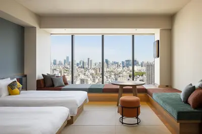 a hotel room with two beds and a large window at OMO5 Tokyo Gotanda by Hoshino Resorts in Tokyo