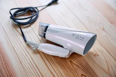 a hair dryer sitting on top of a wooden table at \u3010Hotel Futaba HeightsC\u3011good access, up to 5 guests in Tokyo