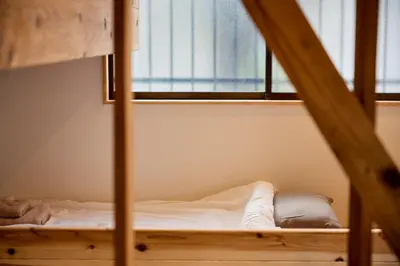 a bed in a room with a window at \u3010Hotel Futaba HeightsC\u3011good access, up to 5 guests in Tokyo