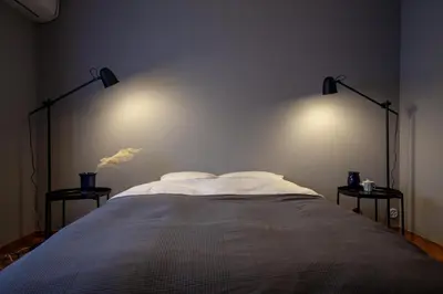 a bedroom with a bed with two lamps on the wall at Lucky Aoto \u30e9\u30c3\u30ad\u30fc\u9752\u6238 in Tokyo