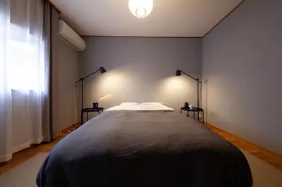 a bedroom with a large bed with two night stands at Lucky Aoto \u30e9\u30c3\u30ad\u30fc\u9752\u6238 in Tokyo
