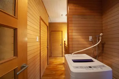 a small bathroom with a washing machine in a room at Lucky Aoto \u30e9\u30c3\u30ad\u30fc\u9752\u6238 in Tokyo