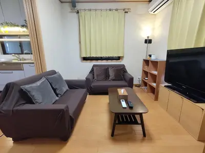 a living room with a couch and a tv at Lucky Higashimizue \u30e9\u30c3\u30ad\u30fc\u6771\u745e\u6c5f in Tokyo