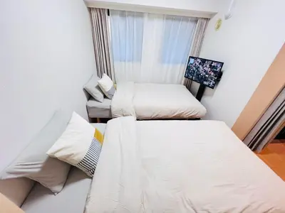 two beds in a small room with a window at JUN Kabukicho-SJ0096 in Tokyo