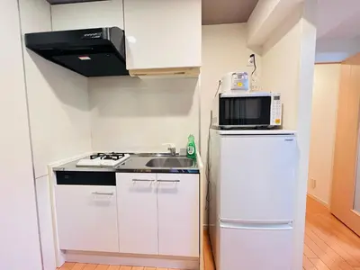a small kitchen with a sink and a microwave at JUN Kabukicho-SJ0096 in Tokyo