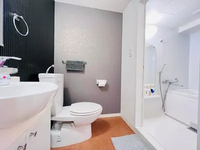 a white bathroom with a toilet and a sink at JUN Kabukicho-SJ0096 in Tokyo