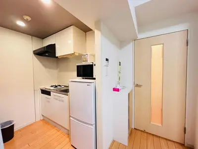 a kitchen with a refrigerator and a stove at JUN Kabukicho-SJ0096 in Tokyo
