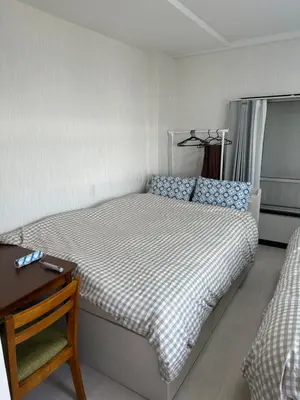 a small bedroom with a bed and a table at QQ Umeyashiki in Tokyo