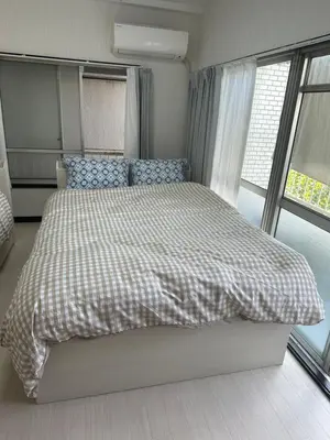 a bedroom with a bed with a checkered blanket at QQ Umeyashiki in Tokyo