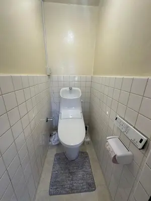 a small bathroom with a toilet in a stall at QQ Umeyashiki in Tokyo