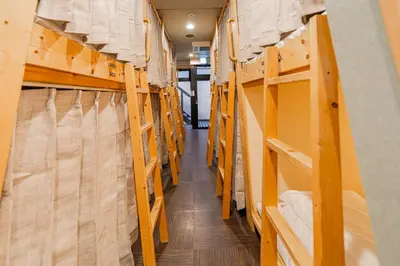 a hallway of a library with wooden shelves at E JOY INN-East Nipoori Branch in Tokyo