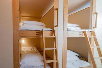 two bunk beds in a room next to each other at E JOY INN-East Nipoori Branch in Tokyo