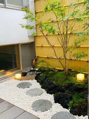 a garden with rocks and a tree in front of a building at JR Line, New Open-KI0299 in Tokyo