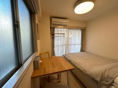 a room with a bed and a desk and a window at Garden square in Tokyo