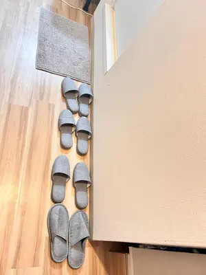 a group of slippers on the floor next to a box at Y-shinjuku kabukicho-SJ0018 in Tokyo