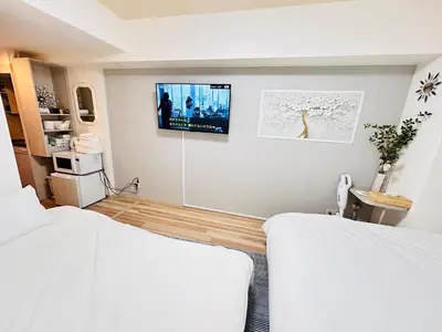 a bedroom with two beds and a tv on the wall at Y-shinjuku kabukicho-SJ0018 in Tokyo