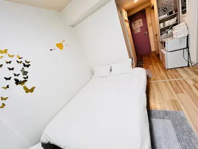 a bedroom with a bed with butterflies on the wall at Y-shinjuku kabukicho-SJ0018 in Tokyo