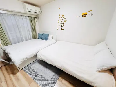 two beds in a room with white walls at Y-shinjuku kabukicho-SJ0018 in Tokyo
