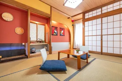 a room with a table and chairs in a room at KYARA Hotel \u767d\u9ce5 in Tokyo