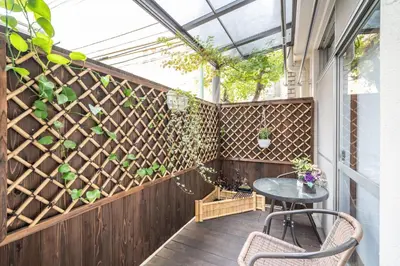 a patio with a table and some plants at KYARA Hotel \u767d\u9ce5 in Tokyo
