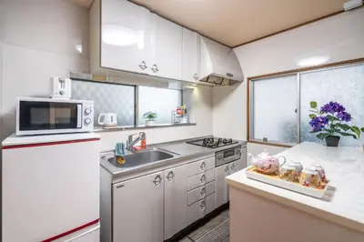 a small kitchen with a sink and a microwave at KYARA Hotel \u767d\u9ce5 in Tokyo