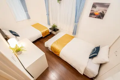a room with two beds and a couch at KYARA Hotel \u6d45\u8349 in Tokyo
