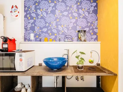 a kitchen counter with a blue bowl on top of it at KYARA Hotel \u6d45\u8349 in Tokyo