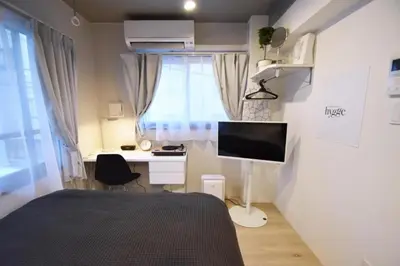 a bedroom with a bed and a desk and a monitor at Ethos Ebisu 201 - Vacation STAY 09298v in Tokyo