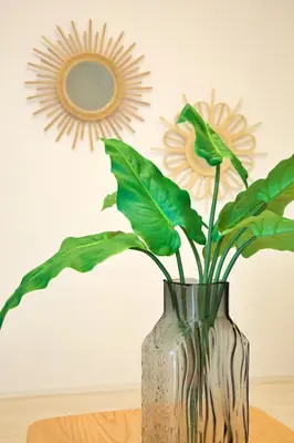 a vase with a plant in front of a mirror at FINOA Residential Suite Kameari in Tokyo