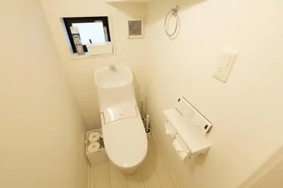 a white bathroom with a toilet and a sink at FINOA Residential Suite Kameari in Tokyo