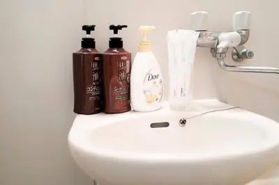 a bathroom sink with two bottles ofodorizers on it at F501 Shinkoiwa Sta 5min Free Wi-Fi Max 5 people in Tokyo