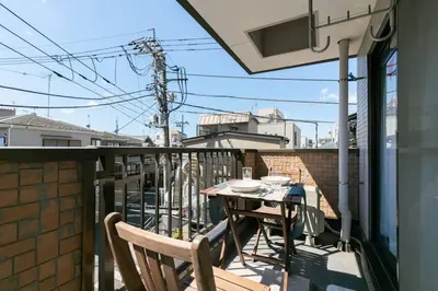 a balcony with a table and chairs on a balcony at F501 Shinkoiwa Sta 5min Free Wi-Fi Max 5 people in Tokyo
