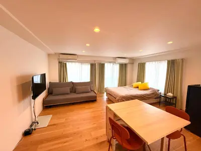 a living room with a bed and a couch at home Shinjuku west302 in Tokyo