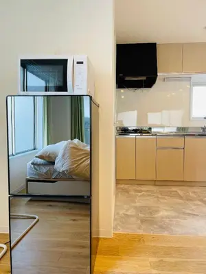 a kitchen with a bed and a microwave in a room at home Shinjuku west302 in Tokyo
