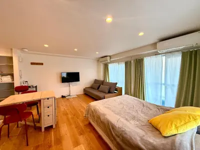 a bedroom with a bed and a desk and a couch at home Shinjuku west302 in Tokyo