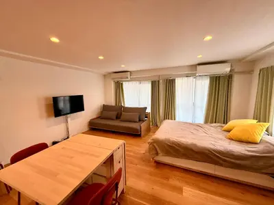a bedroom with a bed and a couch and a table at home Shinjuku west302 in Tokyo