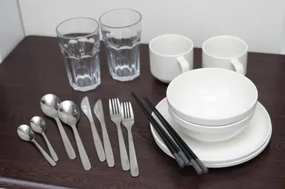 a table with silverware and glasses on a table at IKEBUKURO MANGA HOUSE in Tokyo