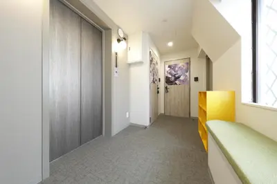 a hallway of a house with a door and a window at IKEBUKURO MANGA HOUSE in Tokyo