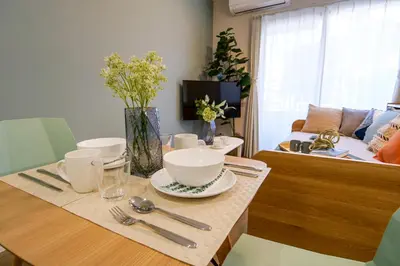 a dining room table with bowls and utensils on it at Premium Apartment Hotel Tokyo East in Tokyo