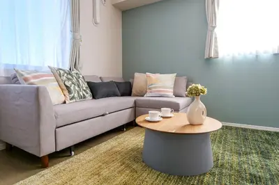 a living room with a couch and a table at Premium Apartment Hotel Tokyo East in Tokyo