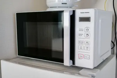 a microwave oven sitting on top of a counter at Premium Apartment Hotel Tokyo East in Tokyo