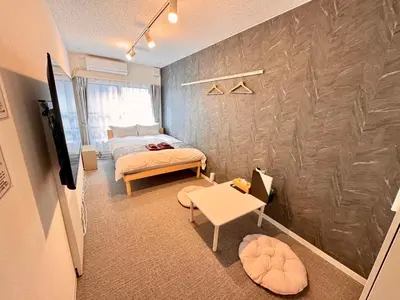 a small bedroom with a bed and a table at Rento Park Shiba301 in Tokyo