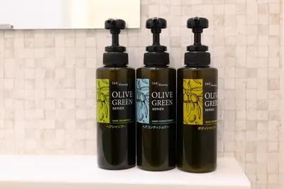 two bottles of olive green liquids sitting on a counter at Rento Park Shiba301 in Tokyo